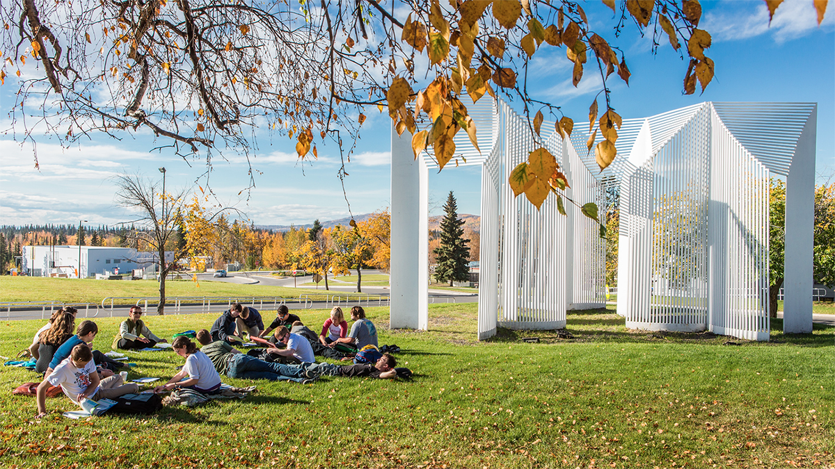 A German foreign language class holds class on the campus lawn during a warm autumn afternoon. | UAF Photo by Todd Paris