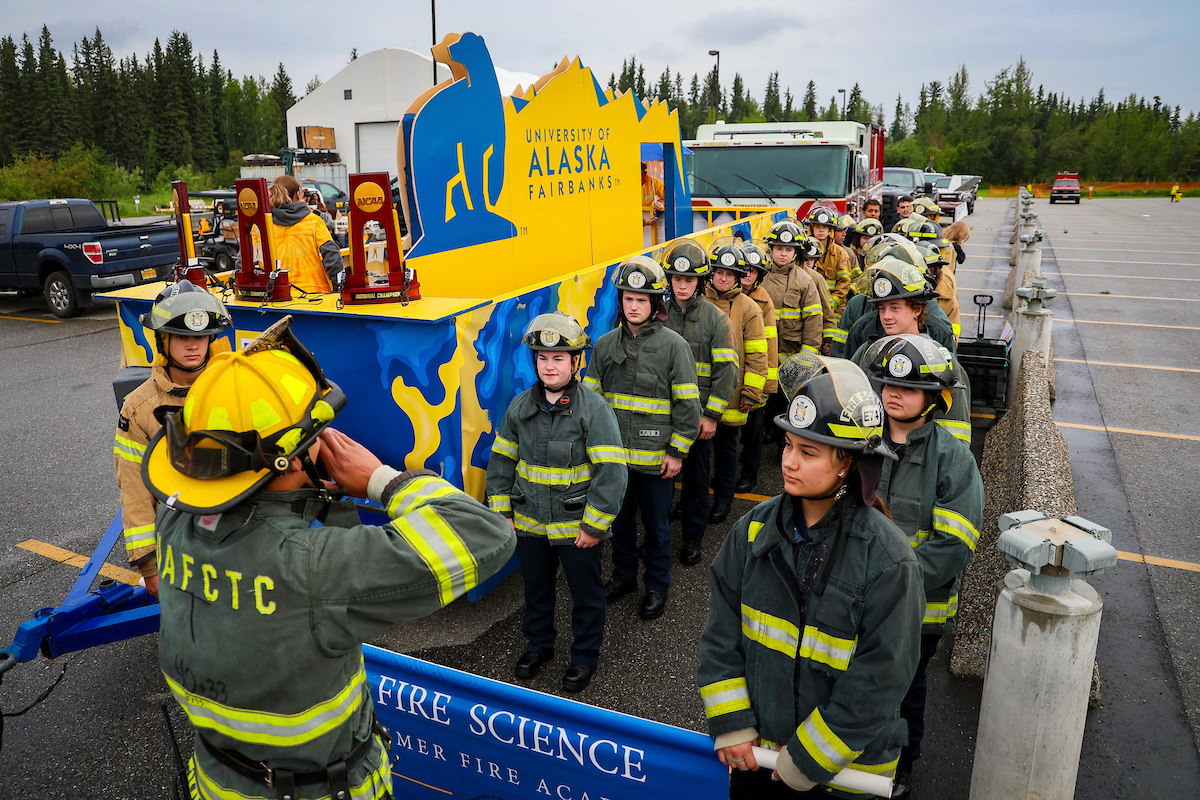 Students enrolled in the UAF CTC Fire Science Academy stand in attention as their captain gives them orders before the start of the 2023 Golden Days Parade