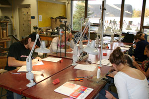 students at work on the bench in the metalsmithing studio
