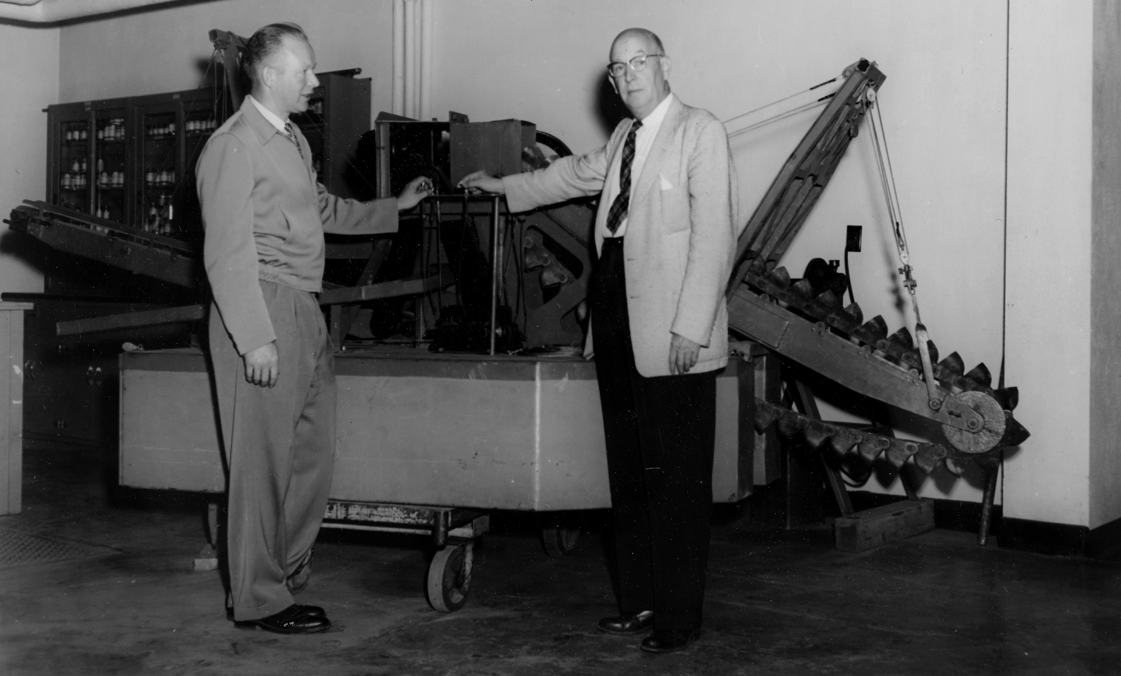 School of Mines Dean Earl Beistline, left, and UA President Ernest Patty inspect a working model of a gold dredge, No. 2 1/2 Nyac. William Race ’42 gave the model to the university in 1958, 20 years after it was built for the New York Alaska Gold Dredging Corp. The company operated full-size dredges at Nyac in Southwest Alaska. Such dredges were an important source of employment for students and graduates of the university’s mining programs. Earl Beistline Collection, Accession number 1985-093-228, Archives, Alaska and Polar Regions Collections, Rasmuson Library, University of Alaska Fairbanks