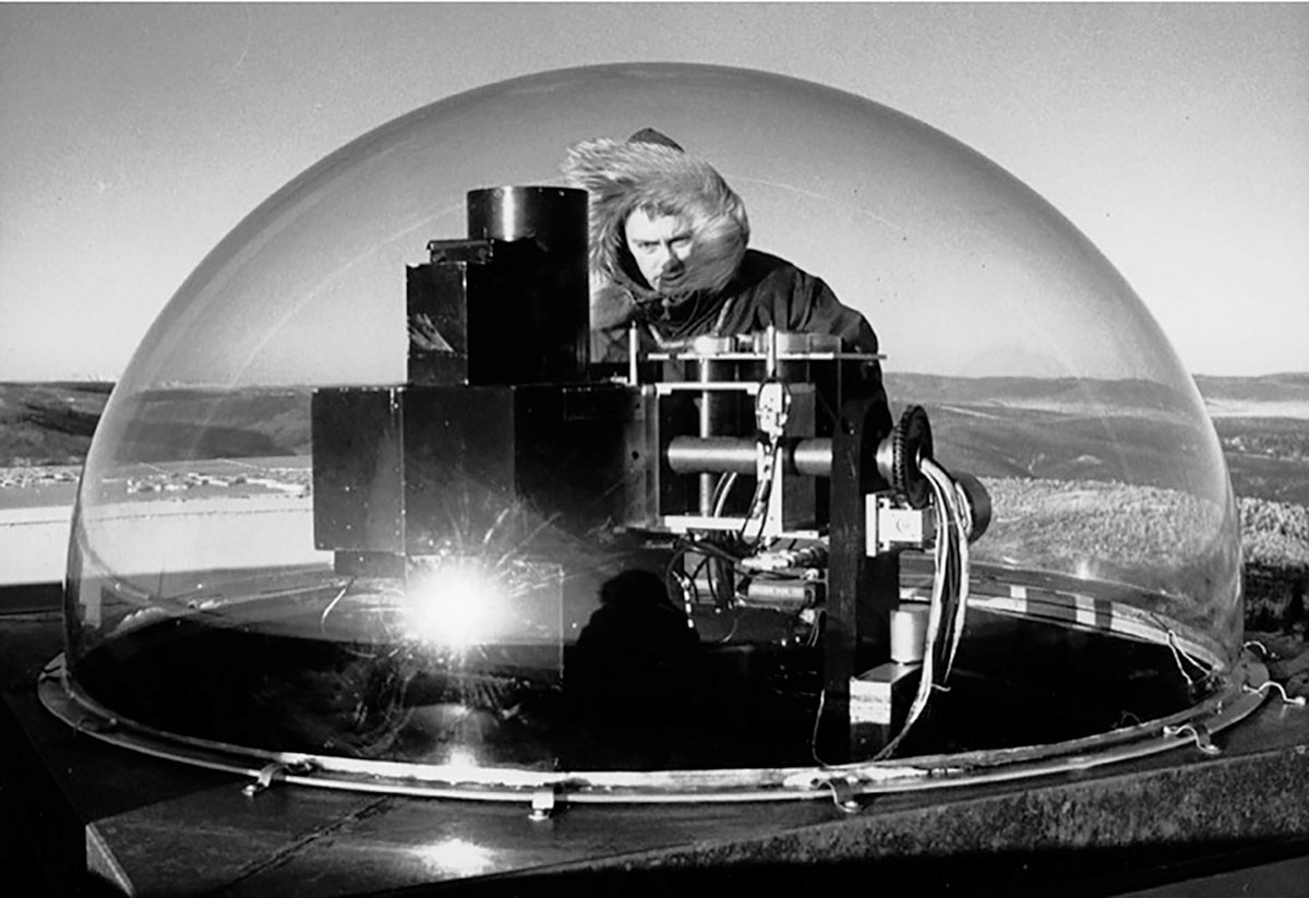 Chuck Deehr looks at his all-sky scanning photometer on the roof of the Ester Dome auroral observatory in about 1965. The photometer measured the intensity of emissions from sodium, lithium and atomic oxygen in the night sky. Photo by Harry Groom.