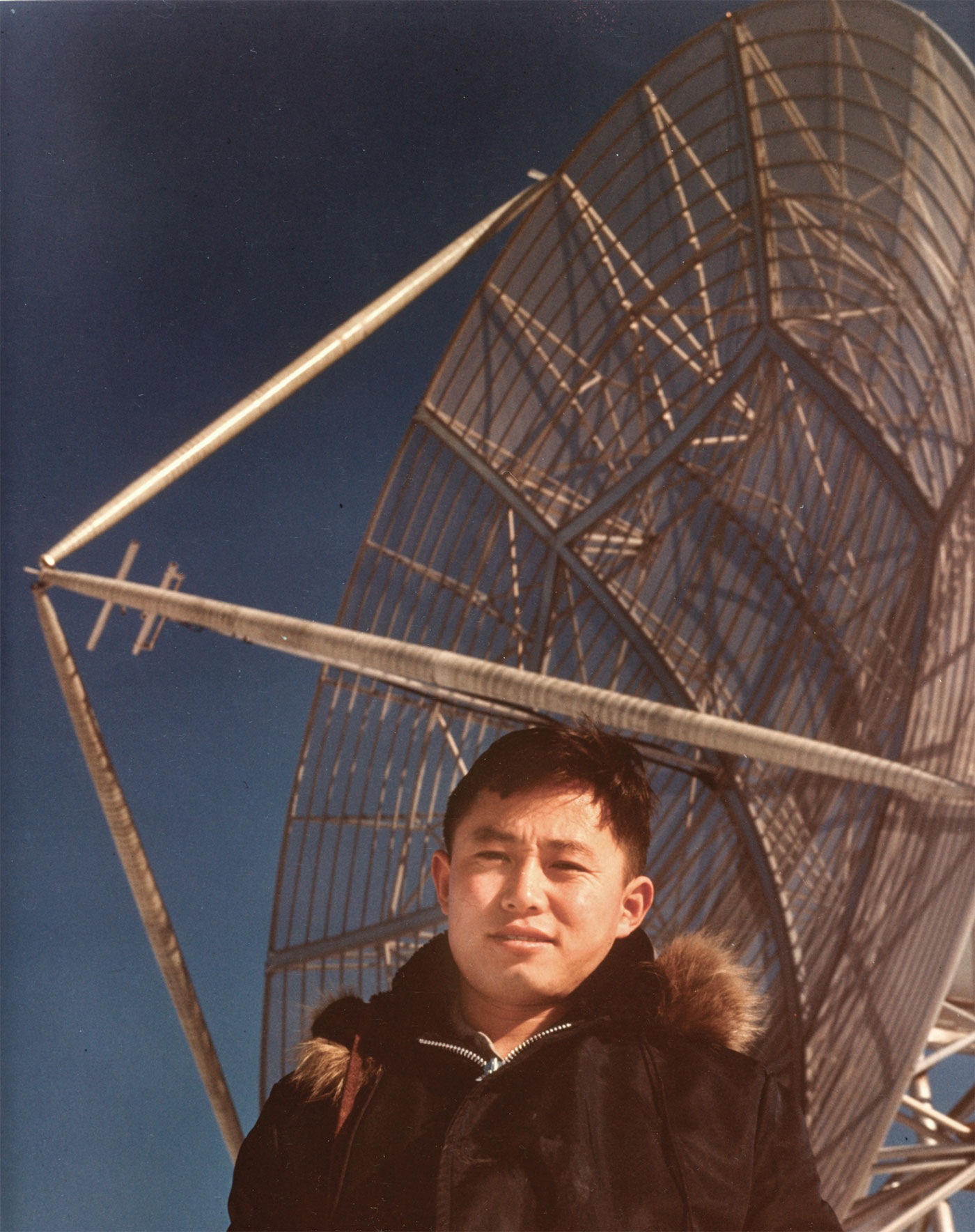 In 1959, Syun Akasofu stands by an antenna near where the International Arctic Research Center sits today. The antenna was the only structure on West Ridge at the time. Photo by Chuck Deehr.