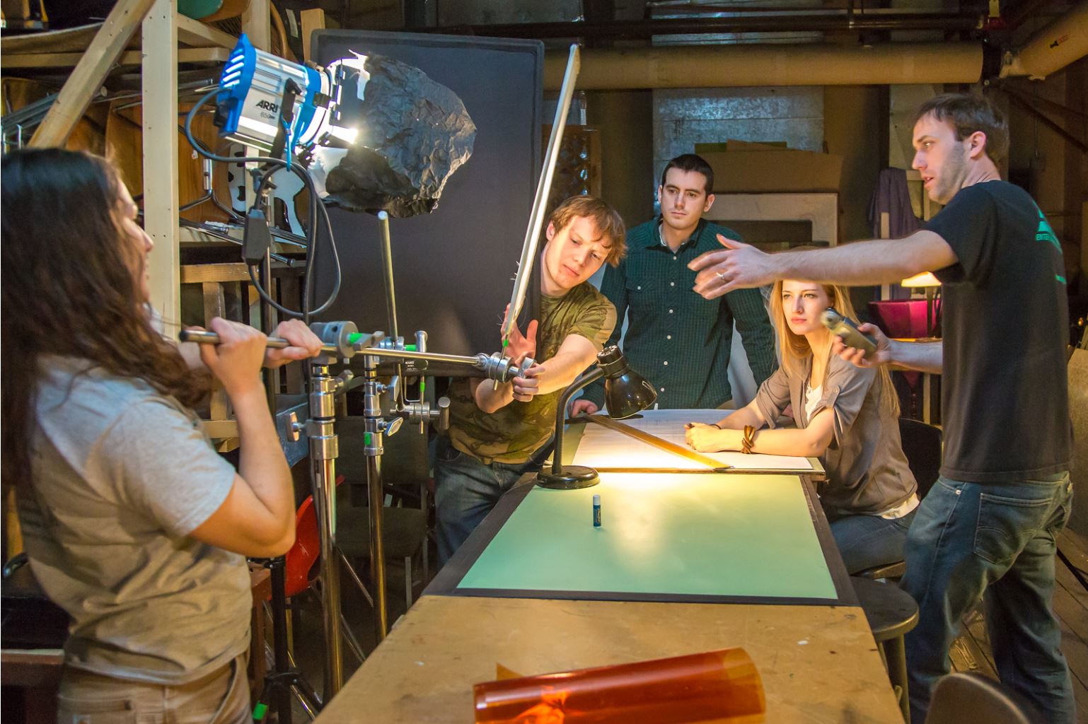 Guest lecturer Dave Selle, right, instructs students on lighting for a scene during the 2013 Wintermester cinematography class in the UAF Fine Arts complex.
