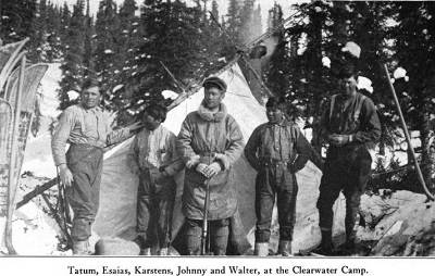 Black and white photo of five men standing outside a tent.