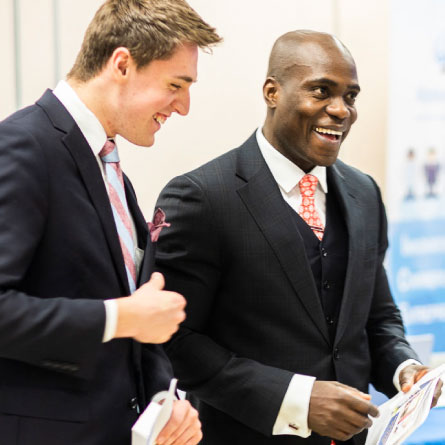 Two students in suits attend the UAF career fair