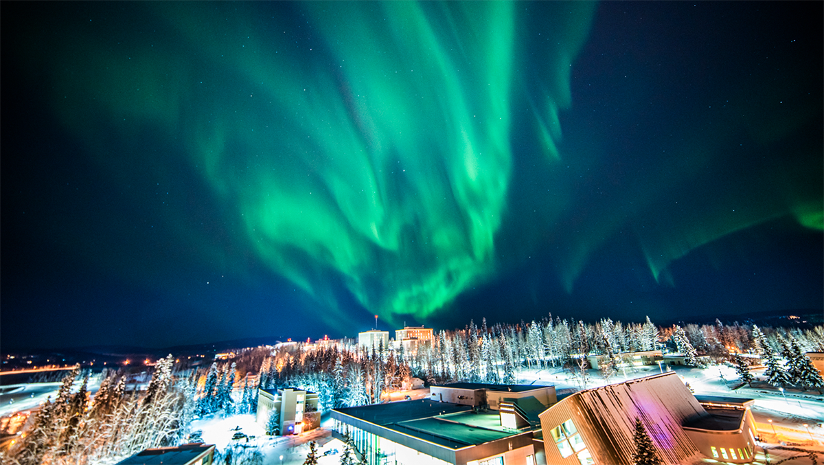 The northern lights dance over the top of campus. Photo taken from the roof of Gruening. | UAF Photo by Zayn Roohi