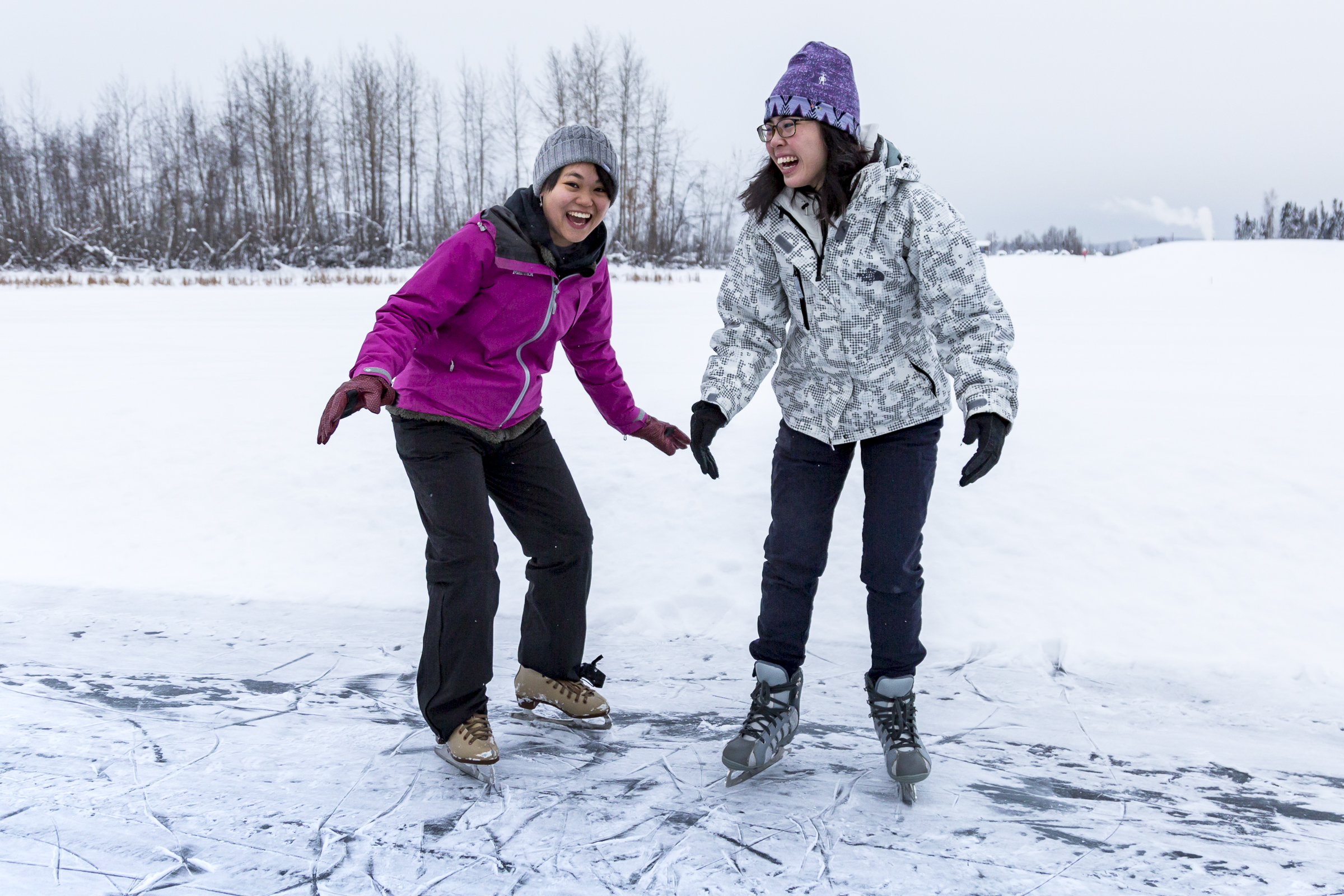 Kasugahara Miki (left) and Natalie Tan Rei Hsi (right) ice skate on the frozen Tanana Lake with Nanook Recreation on Sunday, February 3rd, 2019. | UAF Photo by Sarah Manriquez