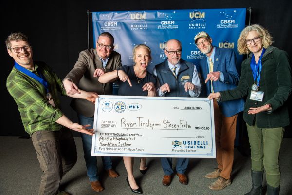 Ryan Tinsley and Stacey Fritz, Arctic Innovation Competition main division champions, hold their first-place check surrounded by representatives from Usibelli Coal Mine and UAF officials.