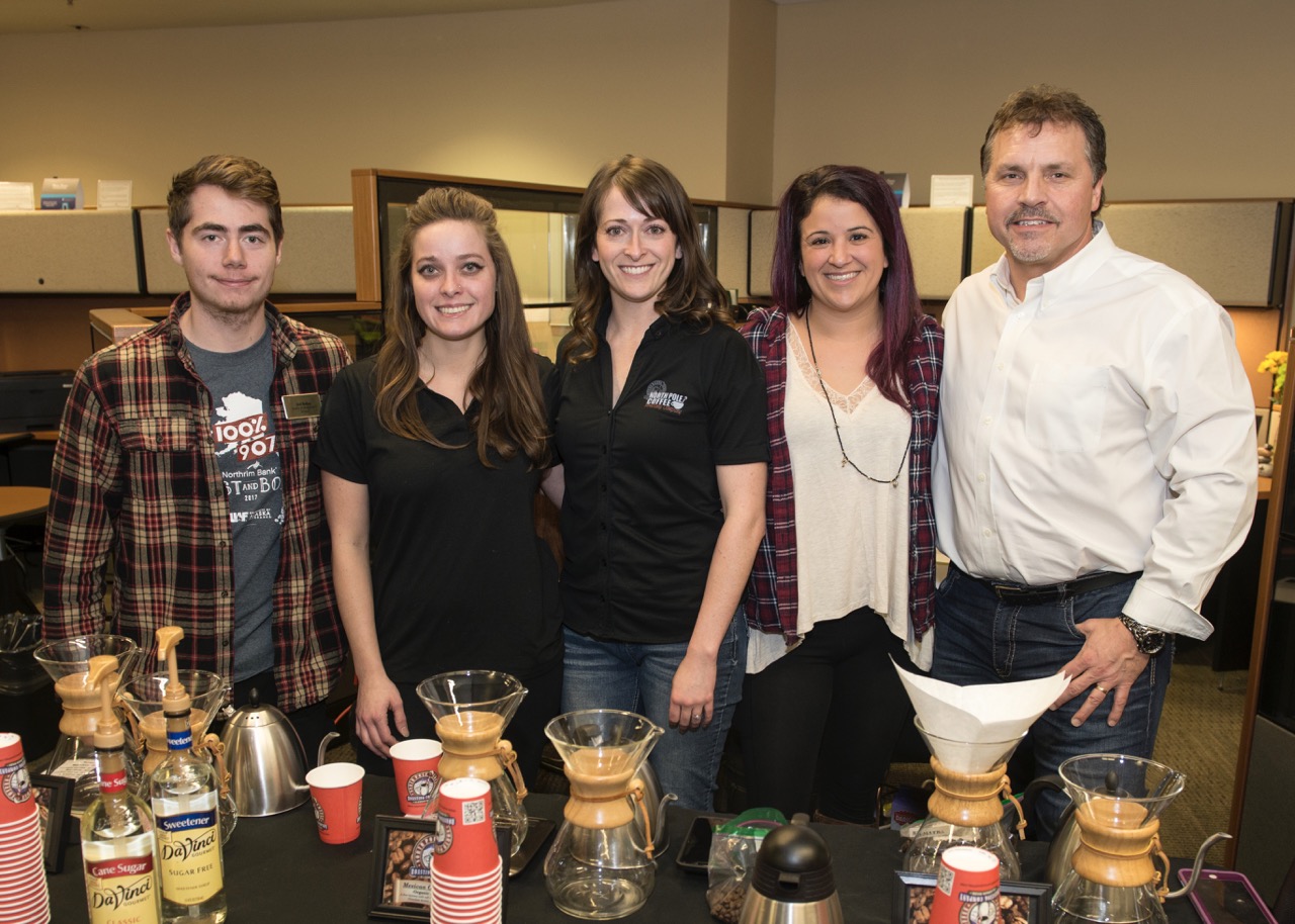 tom bartels stands with students and employees at coffee event 