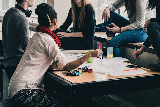 Students gathered around a desk 