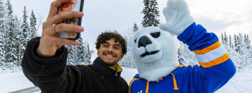 UAF student take a selfie with the UAF Mascot