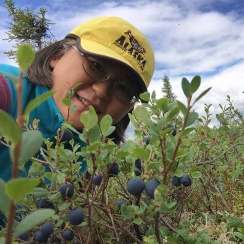 Kugo Yoko takes a selfie with blue berry plants