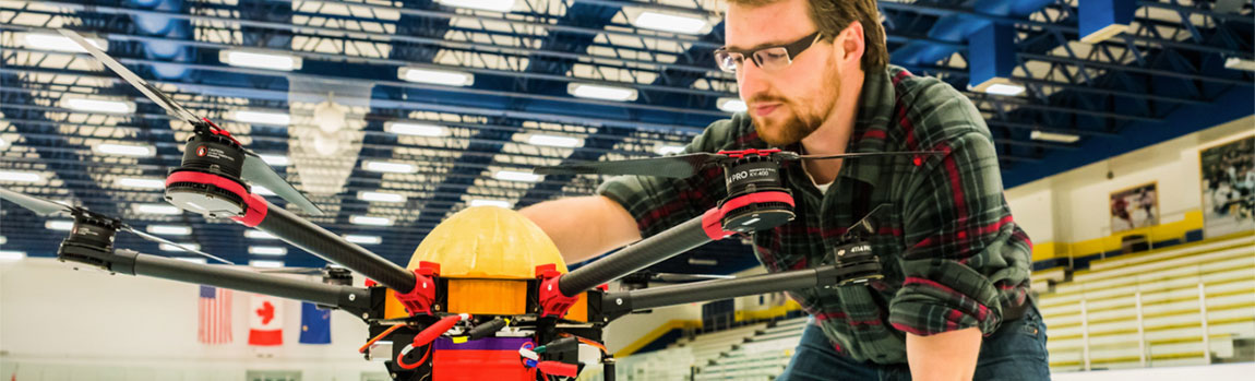 UAF student works on a drone in the Patty Ice Arena