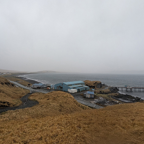 A fishing plant at a bay in a storm.