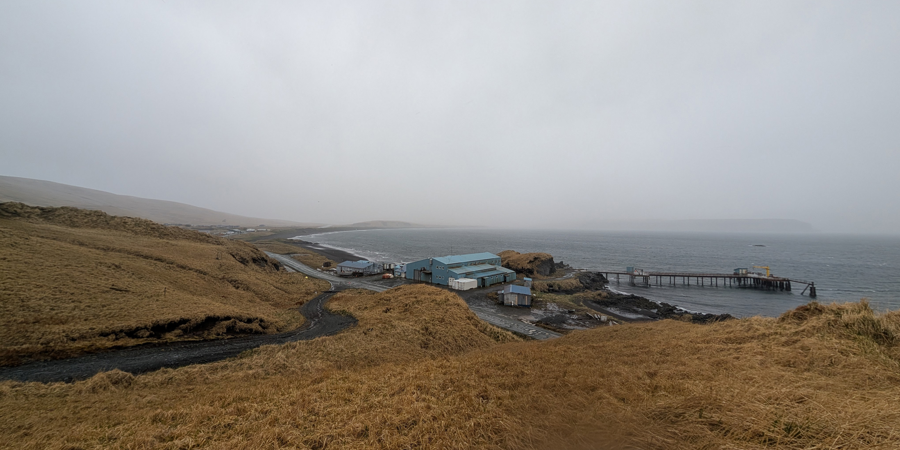 A fishing plant at a bay in a storm.