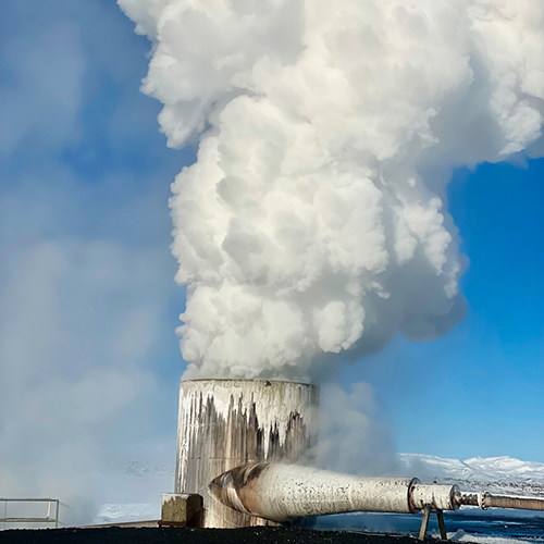 Steam is spewing out of a big pipe