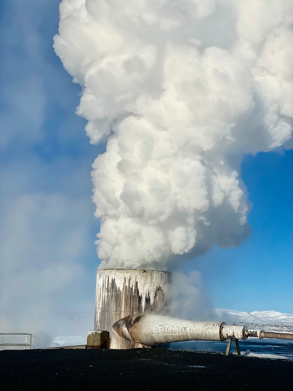 Steam is spewing out of a big pipe