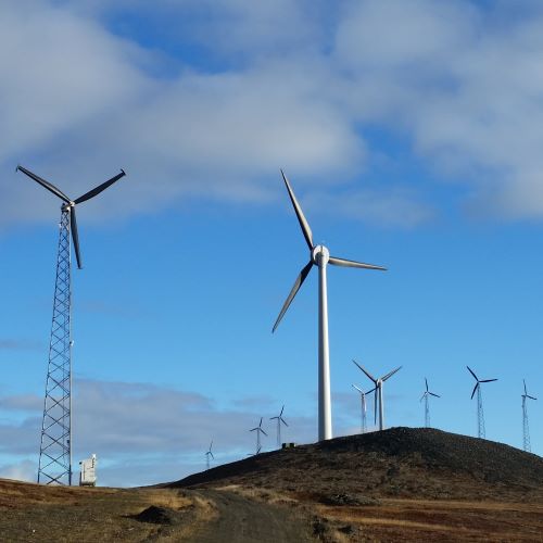 Image of wind turbines on a hill outside Nome, Alaska.