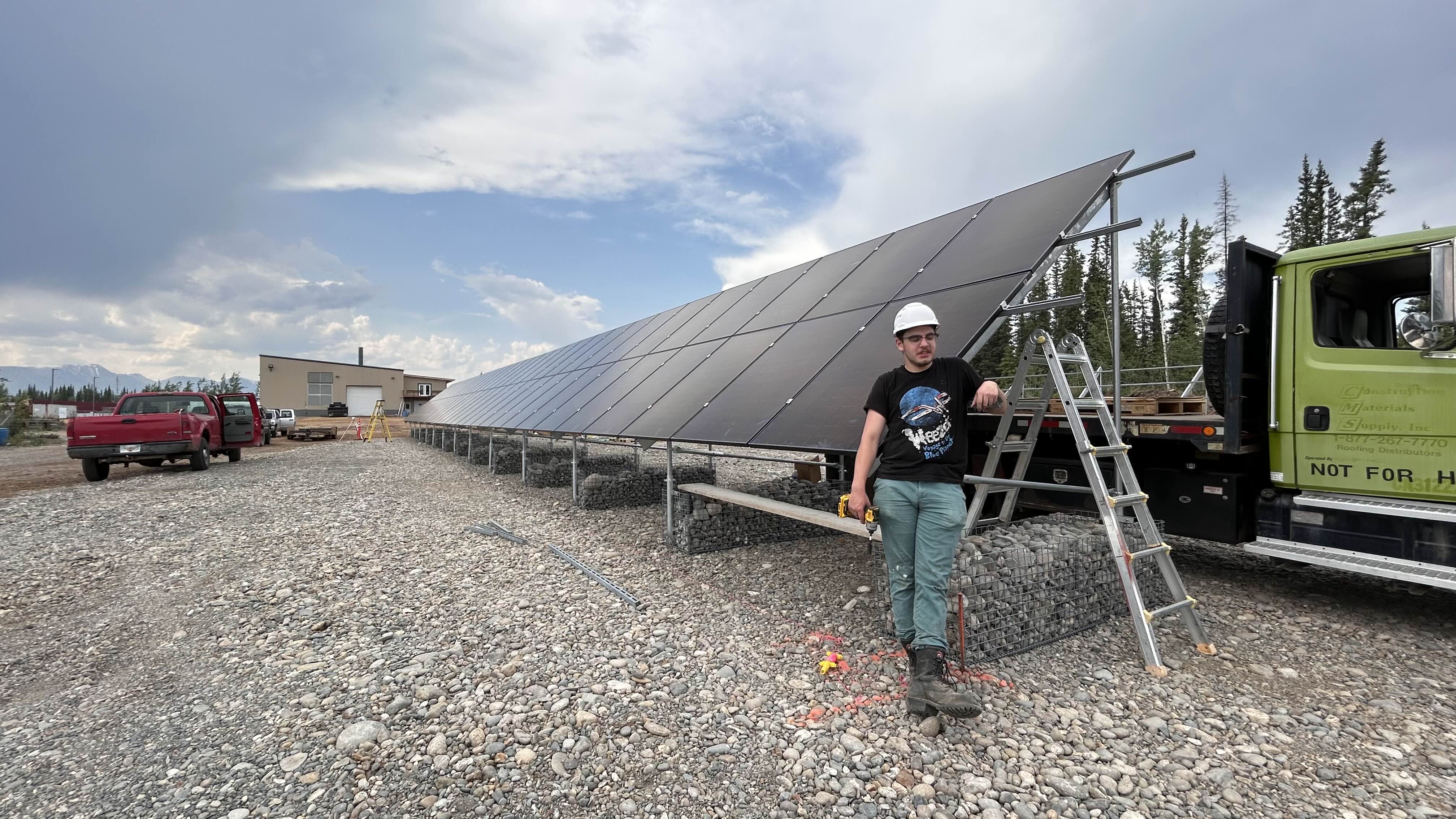A person stands by a solar array