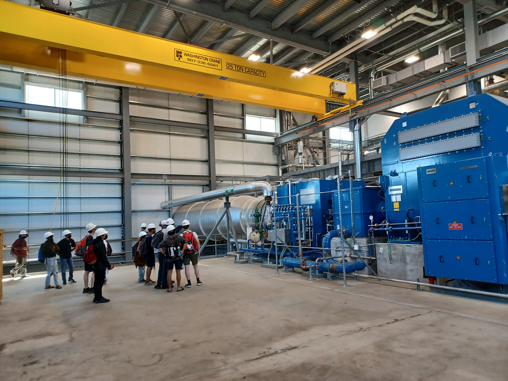 A group of people tour a power plant