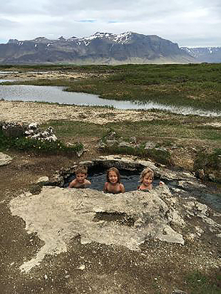 My kids soaking in one of the many natural “hot pots” in Iceland.
