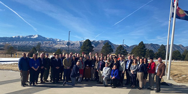 Participants of the Arctic Edge workshop pose for a photo in Colorado with Pikes Peak of the Rocky Mountains in the background. Photo courtesy of the Homeland Defense Institute.