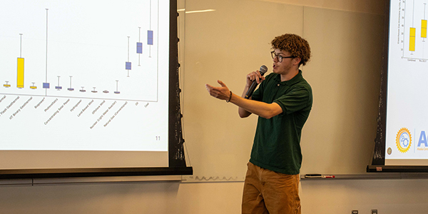 ACEP summer intern Sidney Hackett gives a presentation on his project about geothermal technologies. Photo by Yuri Bult-Ito/ACEP.