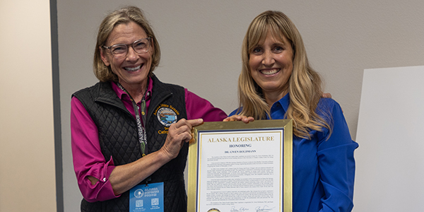 Two people holding a certificate.