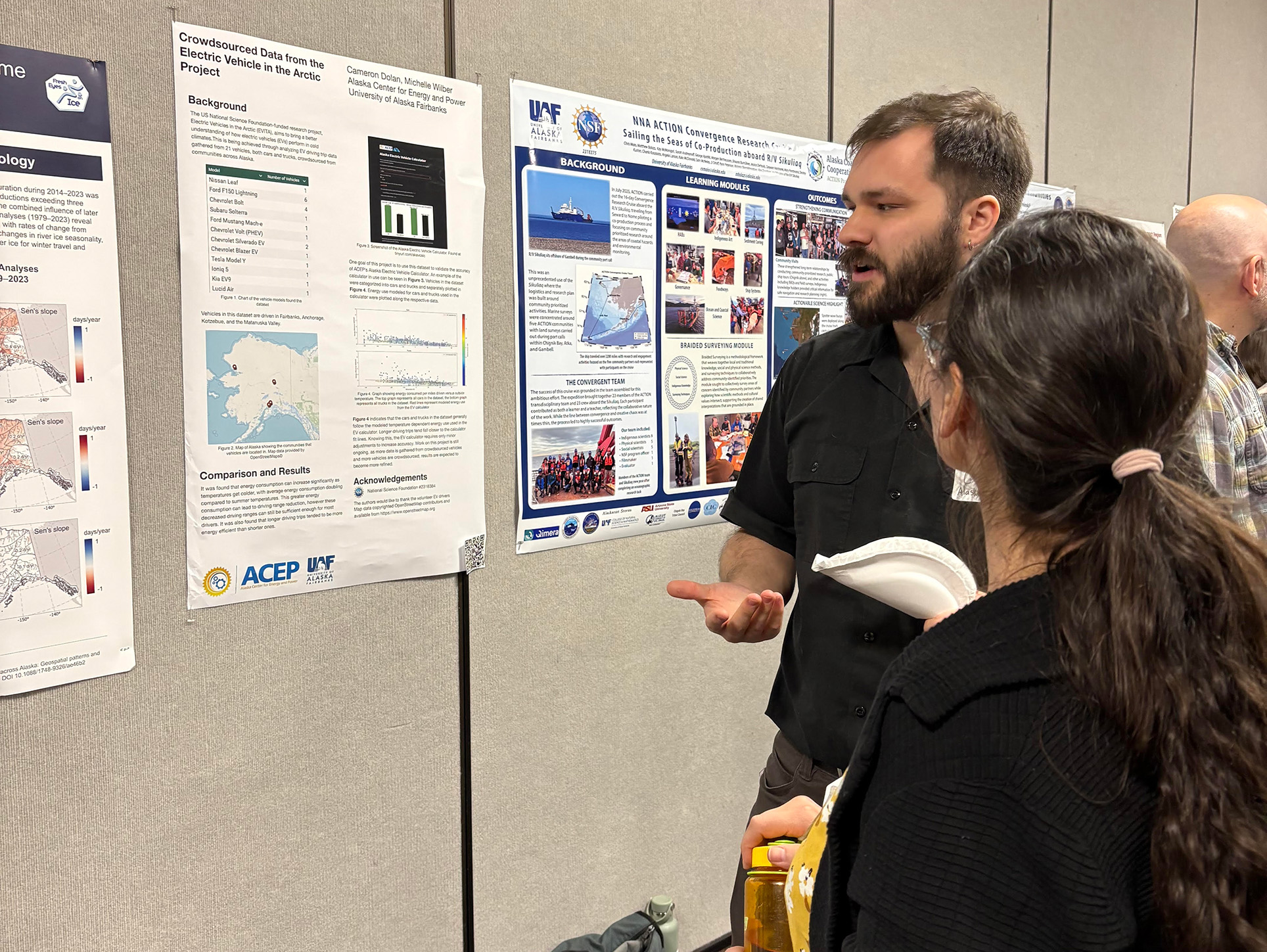 A person is listening to a poster presentor