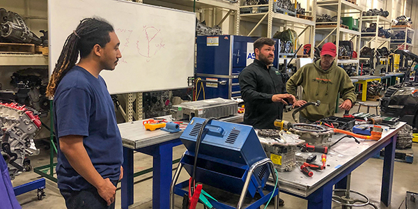 ACEP summer intern Ajey Moses observes an electric vehicle maintenance intensive at the University of Alaska Anchorage, which is part of the NSF-funded Electric Vehicles in the Arctic project. Moses analyzed EV data for the project. Photo by Michelle Wilber/ACEP.