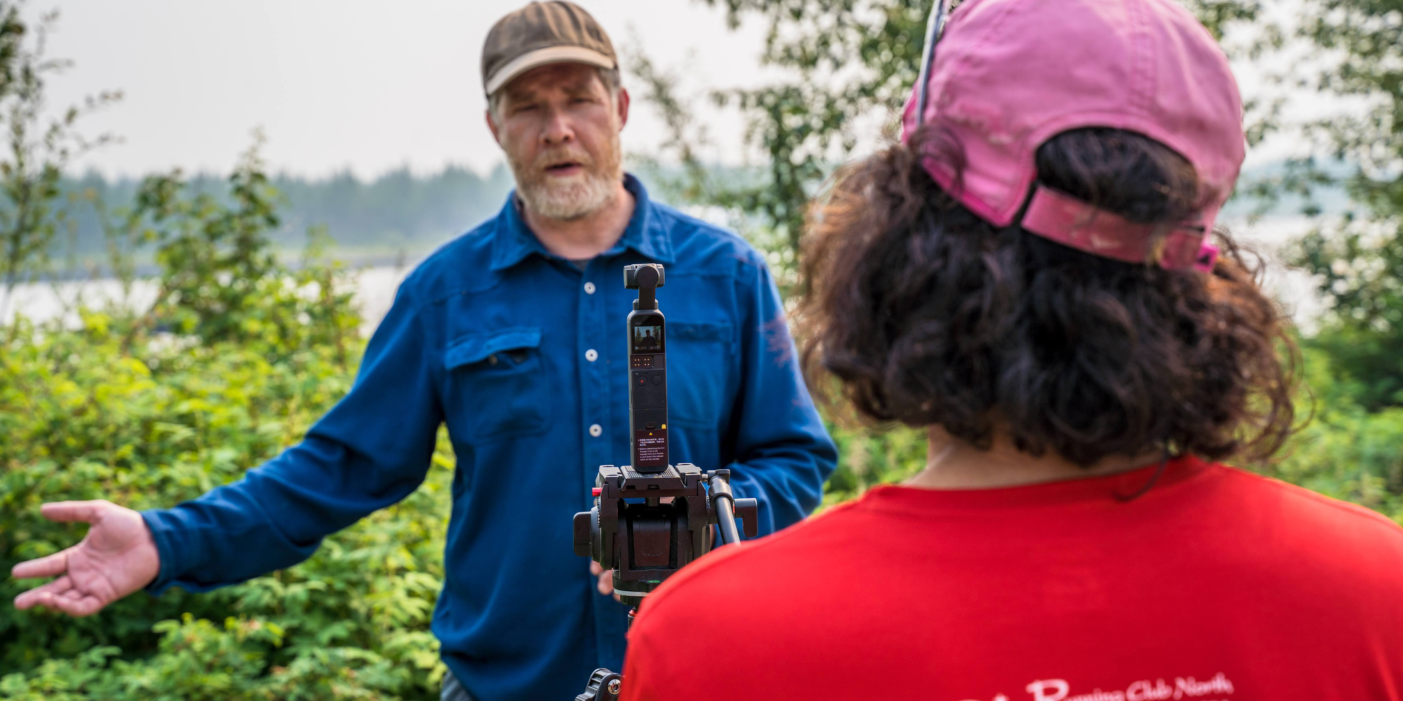 Amanda Byrd records ACEP Director Jeremy Kasper at the Tanana River Hydrokinetic Test Site in Nenana, Alaska, for an Energy in the North episode. Photo by Jeff Fisher.