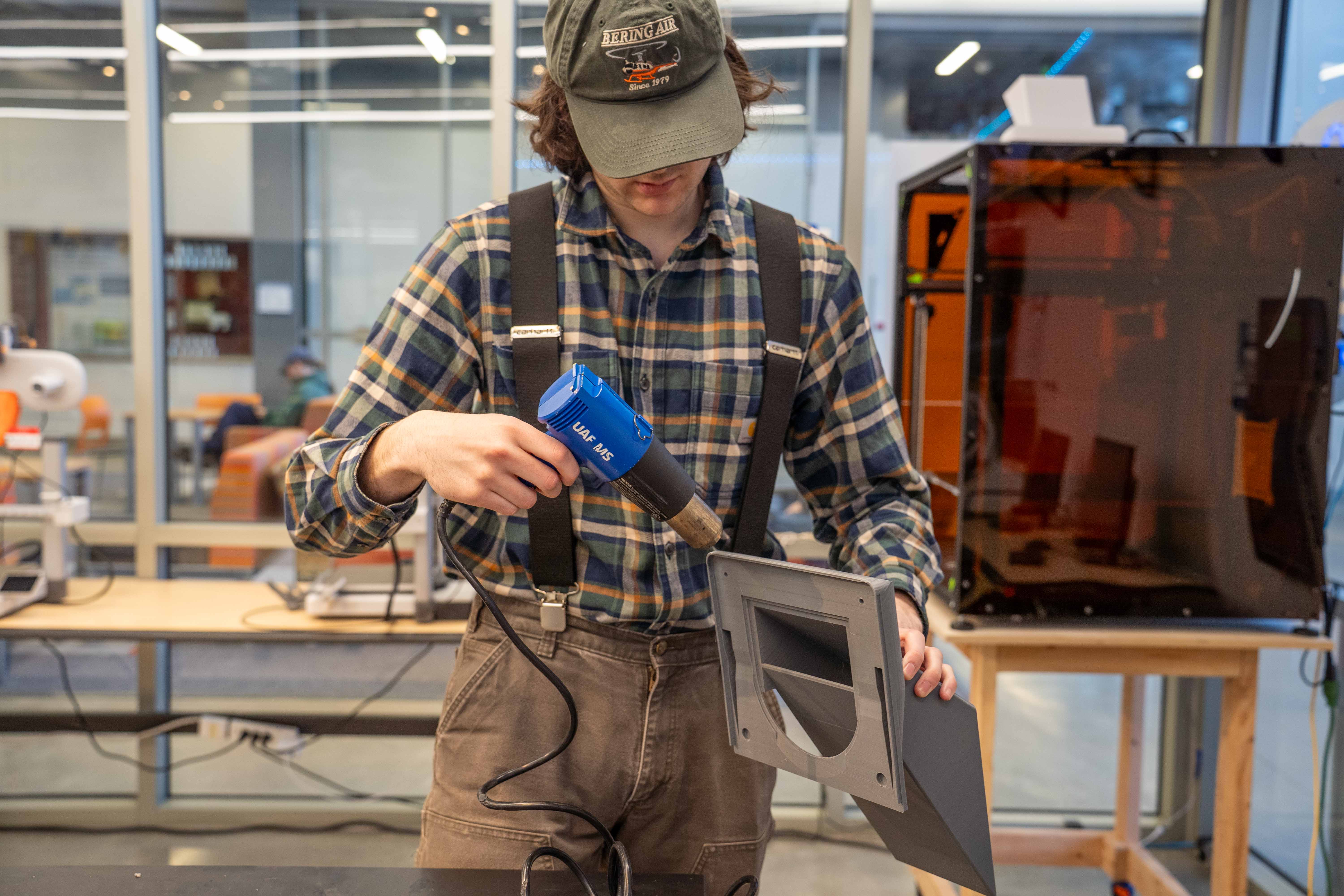 a person cleans debris using a hair-dryer looking instrument