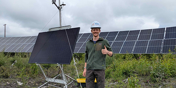 ACEP summer intern Bennett Pearce tours the 8.5-MW Houston Solar Farm in Houston, Alaska, where an agrivoltaics project is taking place. Agrivoltaics is the use of solar panels in agricultural settings to produce both food and electricity. Photo by Shane Morris.