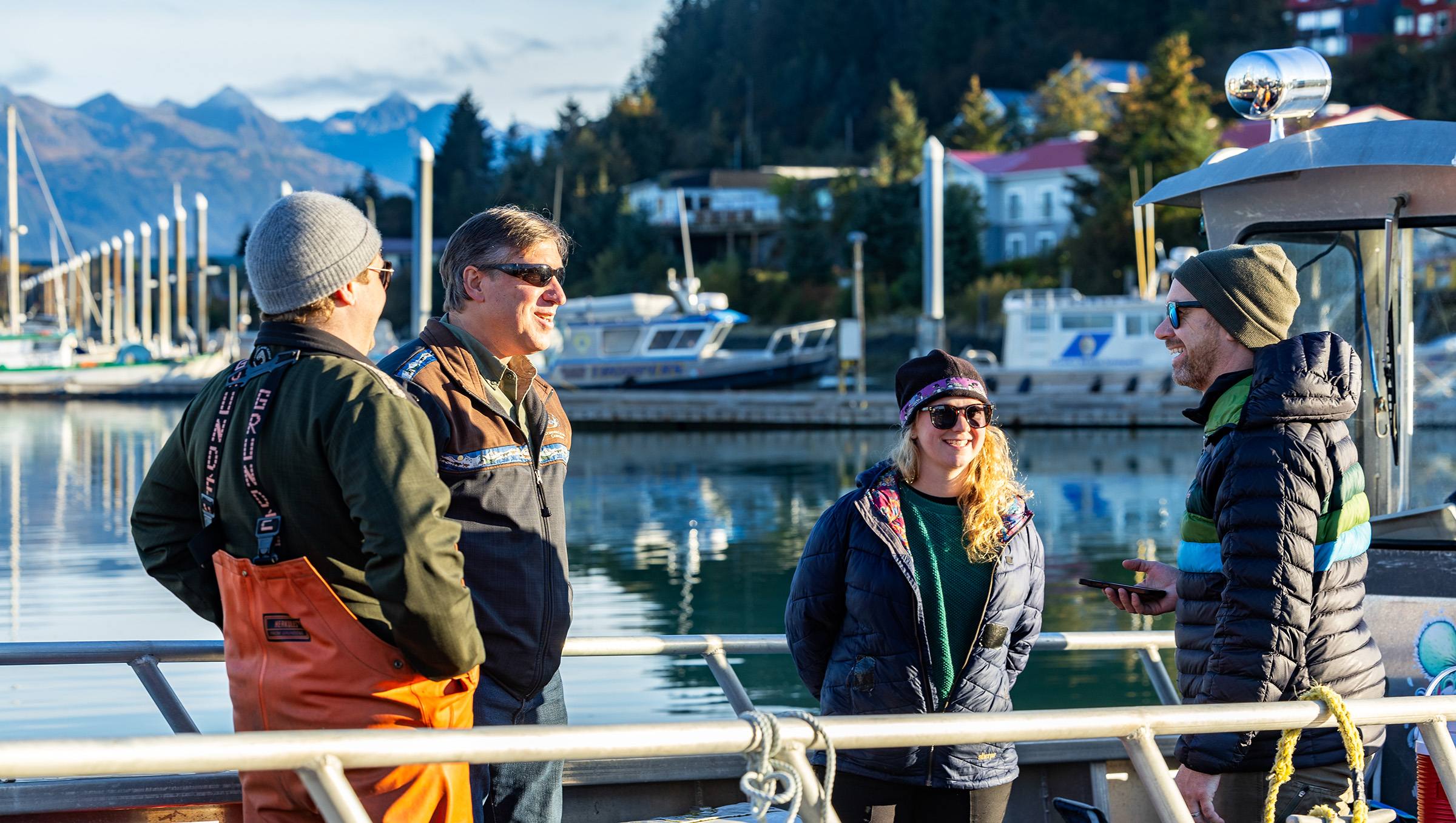Four people talking on a ship