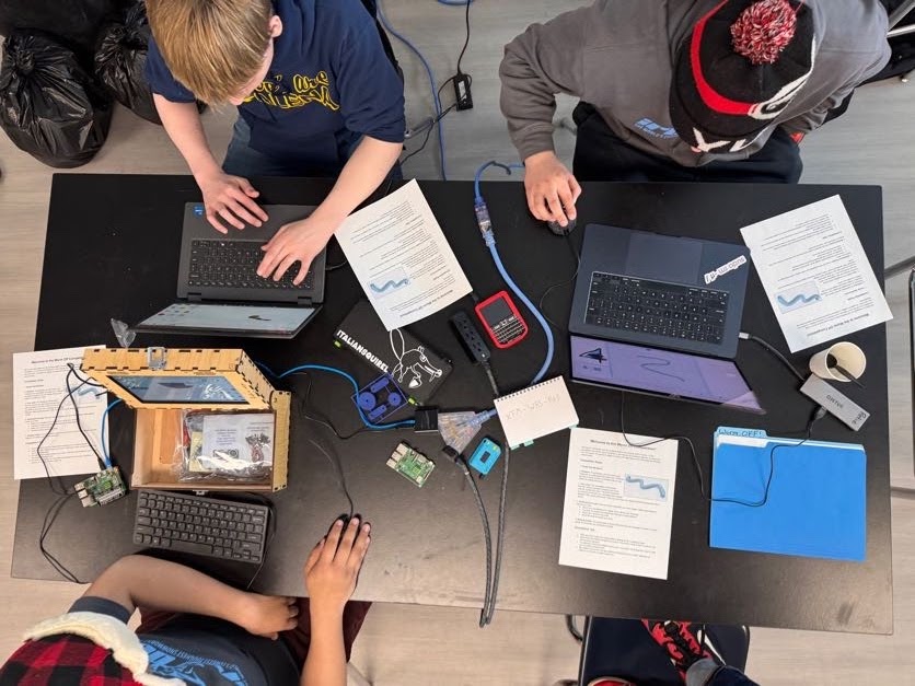 People work on Raspberry Pi computers