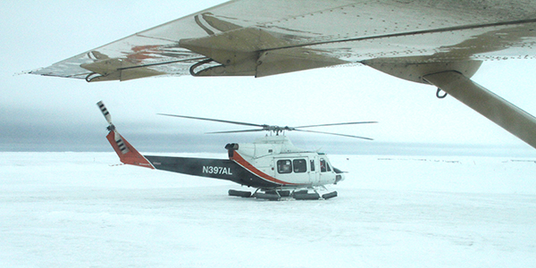 A helicopter sits at an airport