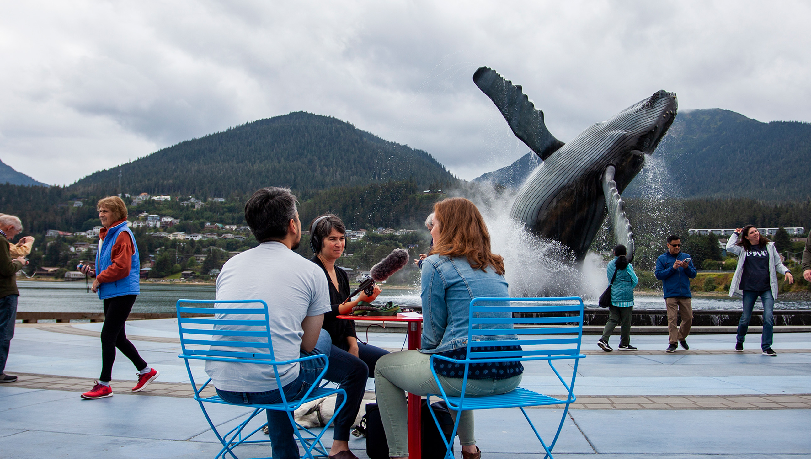 People around a whale statue