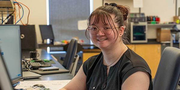 A person smiling at a desk