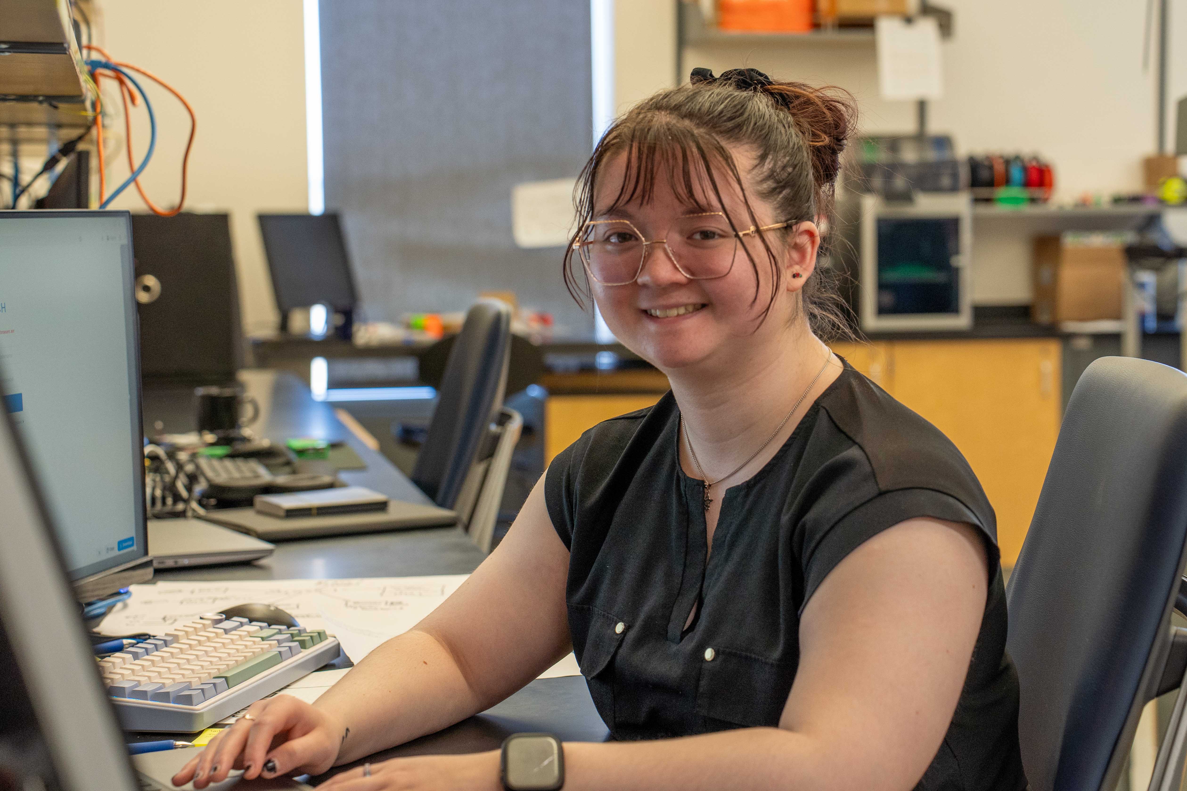 A person smiling at her computer