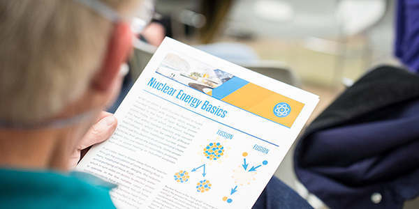 A person reviewing a flyer