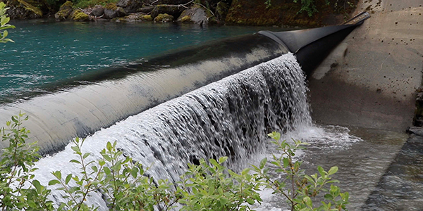 Water flowing over a dam.