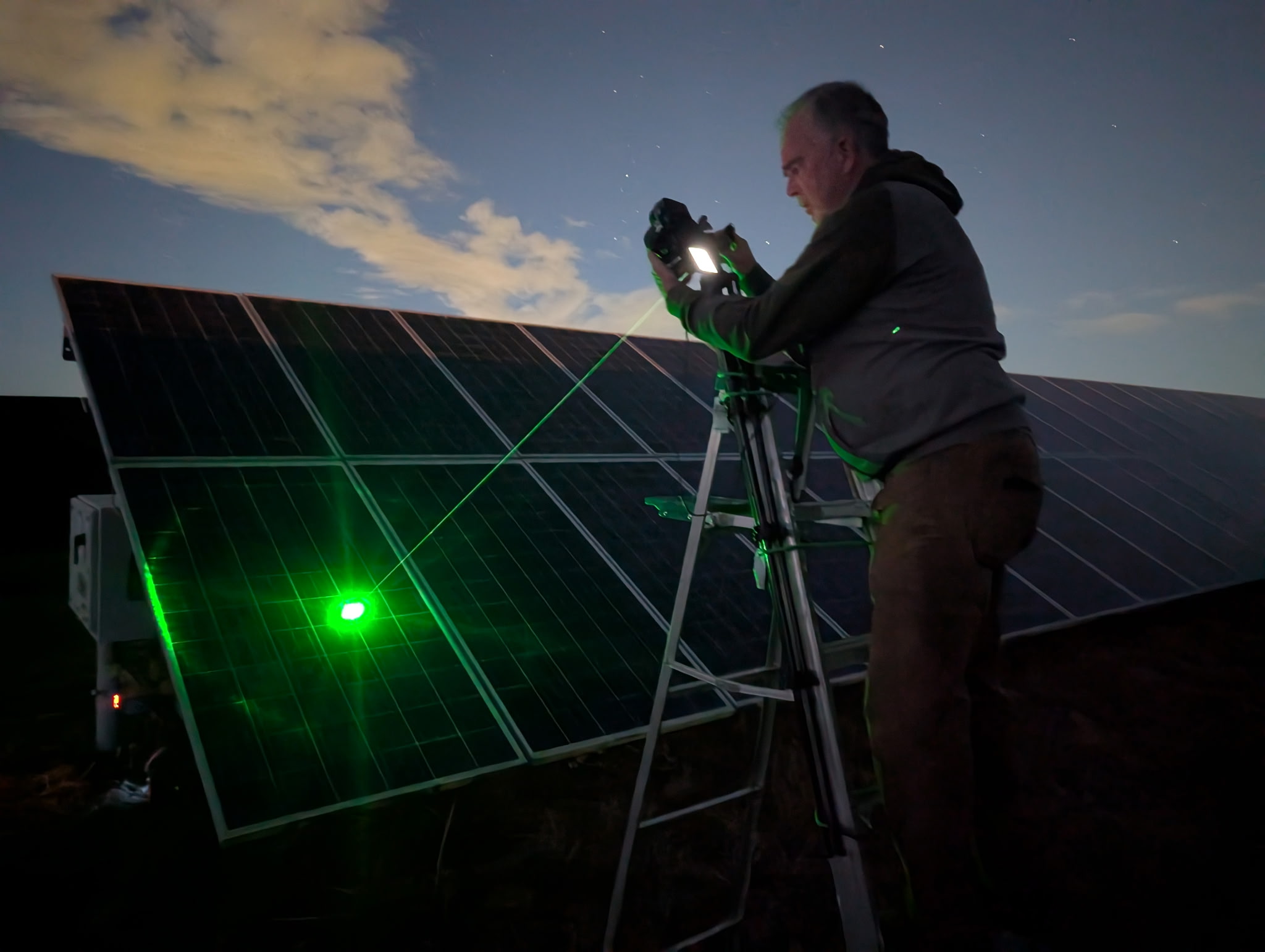 A person is inspecting a solar panel