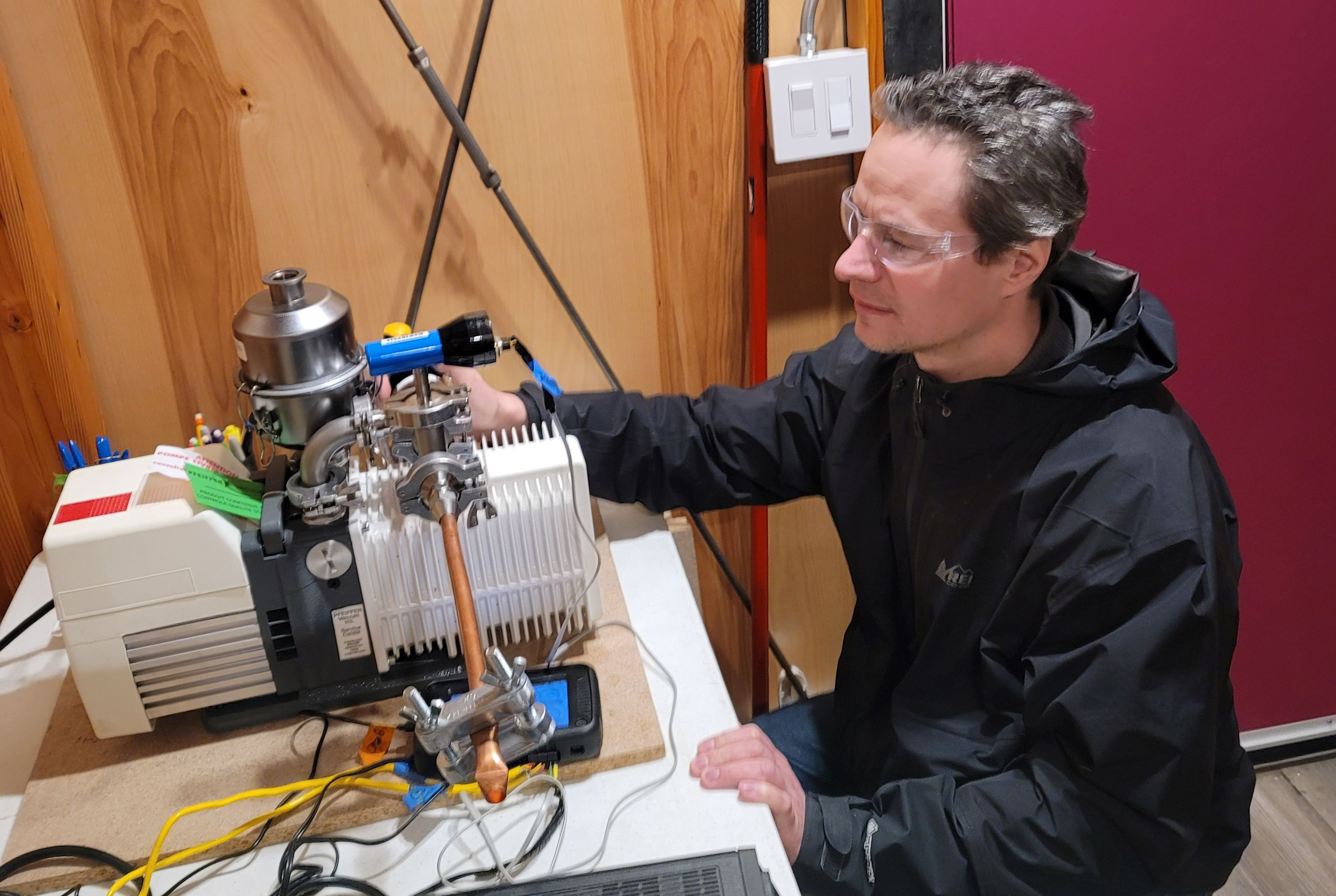 A person is examining equipment