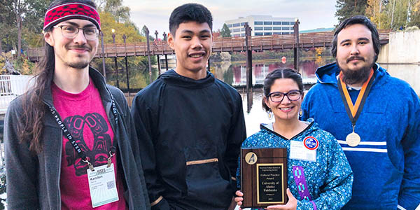 UAF AISES Chapter attendees pose with the Cultural Practice Chapter Award. From left to right: Karsten Sierra, Asa Pitka, Kristen Reece and Bax Bond.