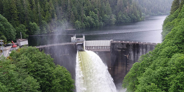 Water spills from a hydroelectric facility at the head of an inlet.