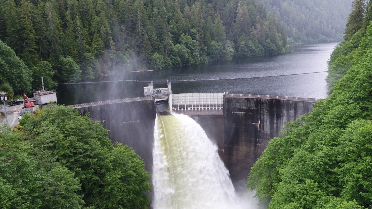 Water spills from a hydroelectric facility at the head of an inlet.