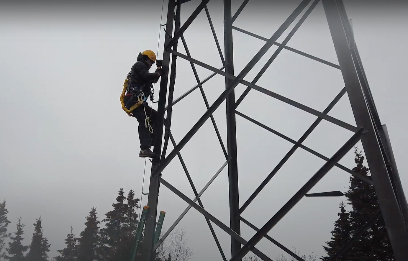 A worker climbing a wind generator