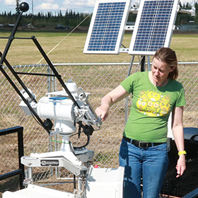 Student researcher inspecting equipment