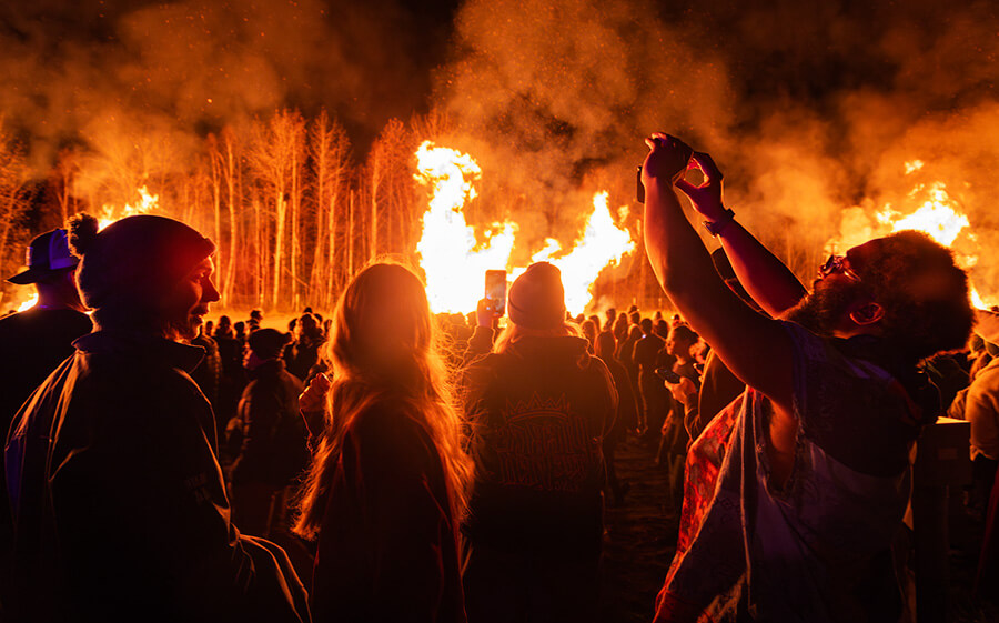 Bonfires are set ablaze as students enjoy the intense heat, dancing and table games available at the 2024 Starvation Gulch event held in the Nenana Parking Lot