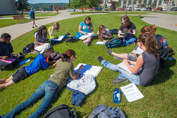 UAF Summer Sessions student attend a class outdoors on the Fairbanks campus.